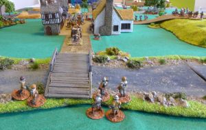 Sappers waiting to destroy the bridge while the first carts leaves the village.